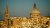 The Carmelite Church (large dome on the right) and St. Paul's Pro-Cathedral tower over Valletta, the capital city of Malta in the warm light of late afternoon.

Despite being a remarkably Catholic country, St. Paul's is an Anglican church, commissioned by Quene Adelaide and completed in 1844. 

The Carmelite Church was completed in 1573 but, like all of Valletta, was badly damaged in World War II. The dome on it was actually added during reconstruction after the war and, interestingly enough, was