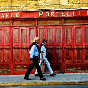 A door, a sign, a walking couple